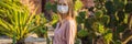 BANNER, LONG FORMAT beautiful stylish young woman in pink dress in desert among the cacti, wearing a medical mask during Royalty Free Stock Photo