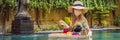 BANNER, LONG FORMAT Breakfast tray in swimming pool, floating breakfast in luxury hotel. Girl relaxing in the pool