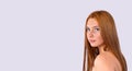 Banner,long format. Caucasian red-haired girl with long hair and big eyes on a gray background with space. Beauty Royalty Free Stock Photo