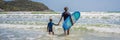 BANNER, LONG FORMAT Father or instructor teaching his son how to surf in the sea on vacation or holiday. Travel and