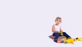 Banner, long format on grey background with plenty space for ads. Sweet child playing with toy cars, adorable blonde funny toddler