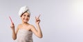 Banner, long format on grey background. Portrait of a smiling pretty woman wearing bath towel, holding toothbrush Royalty Free Stock Photo