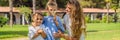 BANNER, LONG FORMAT Happy family outdoors on the grass in a park, smiling faces, having fun Portrait of a disgruntled Royalty Free Stock Photo