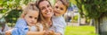 BANNER, LONG FORMAT Happy family outdoors on the grass in a park, smiling faces, having fun Portrait of a disgruntled Royalty Free Stock Photo