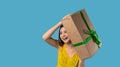 Banner- long format. Holidays, celebration and women concept. Portrait of happy charismatic girl shaking gift box