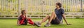 BANNER, LONG FORMAT Little cute kid boy in red football uniform and his trainer or father playing soccer, football on Royalty Free Stock Photo