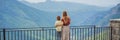 BANNER, LONG FORMAT Mother and son tourists on background of Blue river running through green valley toward distant Royalty Free Stock Photo