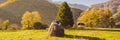 BANNER, LONG FORMAT Scene of sunset or sunrise on the field with haystacks in Autumn season. Rural landscape with cloudy Royalty Free Stock Photo