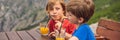 BANNER, LONG FORMAT Two boys friend drink juice, enjoys the view of Kotor. Montenegro. Bay of Kotor, Gulf of Kotor, Boka