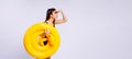 Banner,long format. A young girl lifeguard looks into the distance holding a yellow lifebuoy in her hand. Background