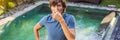 BANNER, LONG FORMAT Young man with disgust on his face pinches nose, something stinks, very bad smell in swimming pool Royalty Free Stock Photo