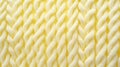 Macro photography of the texture of a knitted pattern in close-up, white and yellow colors, warm clothes Royalty Free Stock Photo