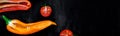 Banner of Mixed of half red and yellow pepper cherry tomato on a black backround Royalty Free Stock Photo