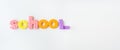 Banner with multi-colored letters. Letters for the study of children in kindergarten or school, fluted letters. School inscription