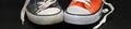 Banner of new orange and old blue sneakers Royalty Free Stock Photo