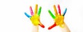 The banner is painted with bright paint the palm of your hand with different colors on a white isolated background. copy space