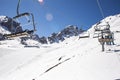 Banner panorama of ski resort, skiers on the ski lift, white snow pine trees at pink sunset or dawn Royalty Free Stock Photo