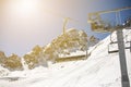 Banner panorama of ski resort, skiers on the ski lift, white snow pine trees at pink sunset or dawn Royalty Free Stock Photo