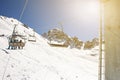 Banner panorama of ski resort, skiers on the ski lift, white snow pine trees at pink sunset or dawn Royalty Free Stock Photo