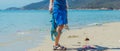 Banner paradise lazur blue sea sand beach in sunny day. Hands of man in transparent gloves pick up plastic bags garbage