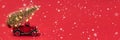 Banner photo of red small retro toy truck with sparkling Christmas tree lights on truck body on red background and flying snow. Royalty Free Stock Photo