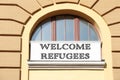 Banner with phrase WELCOME REFUGEES on building Royalty Free Stock Photo