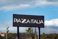 The banner of the Piazza Italia fashion company which sells clothing for men, women, and kids