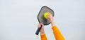 banner pickleball game, hands over blue sky hitting pickleball yellow ball with paddle, outdoor sport leisure activity. Royalty Free Stock Photo