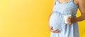 banner portrait cute pregnant unrecognizable woman in floral blue dress hold drink glass of milk on yellow background Royalty Free Stock Photo