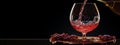 Banner Pouring Red Wine With Splash In A Glass, Grapes On Black Background. Mockup Wine Royalty Free Stock Photo