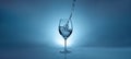 Banner with pouring water into a transparent glass for wine. light blue background with water splashes and copy space Royalty Free Stock Photo