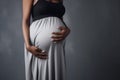 banner pregnant black woman in grey dress holds hands on her belly, AI generated Royalty Free Stock Photo