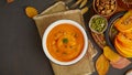 Banner of pumpkin cream soup with walnut and seeds, dark wooden background top view