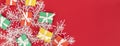 banner with Red, green and yellow gifts on a redbackground with space for text. Colorful scattered Christmas gifts