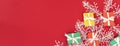 banner with red, green and yellow gifts on a redbackground with space for text. Colorful scattered Christmas gifts
