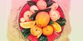 Banner Red plate of oranges and tangerines with green leaves on a light background Top view copy space