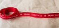Banner. Red ribbon with the words Merry Christmas spread out on craft paper. Place for an inscription
