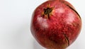 Banner. Red ripe pomegranate fruit against a white background. Anthers on ripe fruit up close. Rind outer skin of pomegranate.