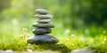 Banner with rock balancing. Stones piled in balanced stacks in front of blurry green garden or forest background with copy space Royalty Free Stock Photo