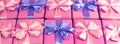 Banner Rows of boxes with gifts decoration ribbon satin bow pink A top view of Flat lay toning