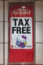 Banner of the Sanrio World Ginza store depicting Hello Kitty holding with the word Tax Free in bold font.