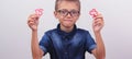 Banner Schoolboy in a blue shirt sitting at the table. Boy with glasses on white background Concept back to school