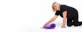 Banner. Senior woman folds the yoga mat at home . White background. Space