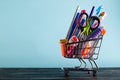Banner of Shopping cart with school supply on a blue background with copy space. Back to school Royalty Free Stock Photo