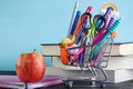 Banner of Shopping cart with school supply on a blue background with a stack of books and an apple with copy space. Back to school Royalty Free Stock Photo