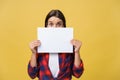 Banner sign woman peeking over edge of blank empty paper with copy space for text. Beautiful Caucasian woman looking Royalty Free Stock Photo