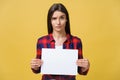 Banner sign woman peeking over edge of blank empty paper with copy space for text. Beautiful Caucasian woman looking Royalty Free Stock Photo