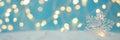 Banner 3:1. Snowflake with defocused lights against blue background. Christmas greating card. Christmas or New Year celebration