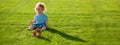 Banner with spring child face. Insurance kids. Baby play in green grass. Warm spring time in the park.