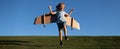 Banner with spring kids portrait. Child boy dreams and travels. Boy jumping and running with airplane toy outdoors